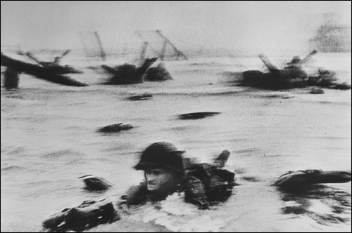 Capa had to face away from the German defenders to get this photo of a 16th Infantry soldier during the landing.
